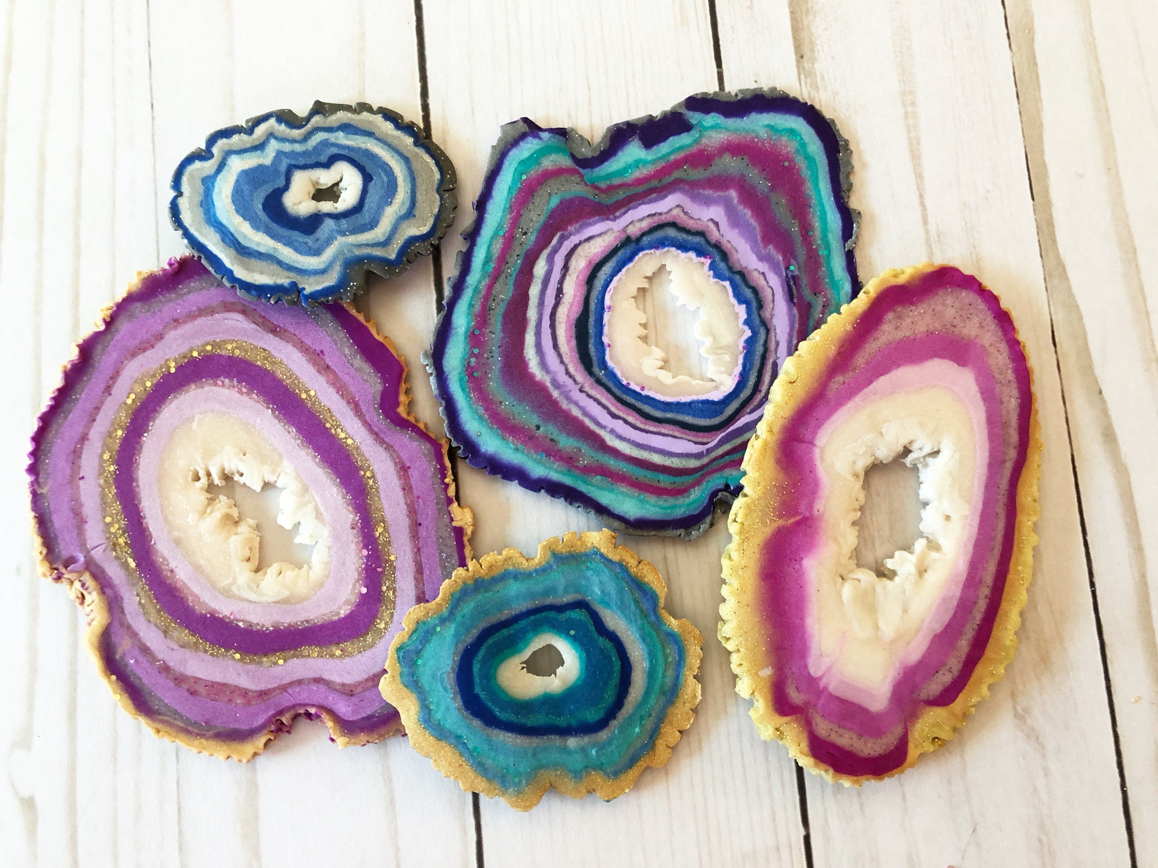 A photograph of faux agate geodes in different colors of blue, gold, purple, and pinks. 