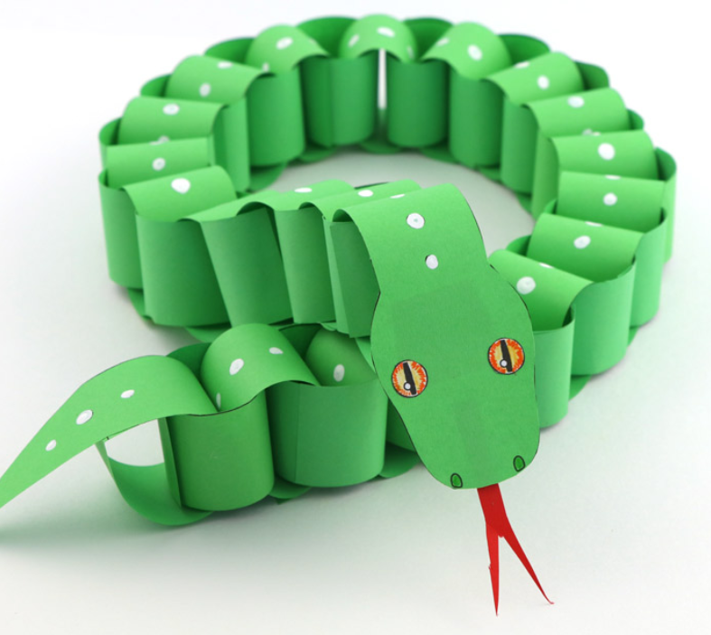 A bright green paper chain python staring out from the screen.