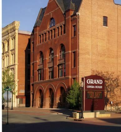 A photograph of the theater, an old brick building.