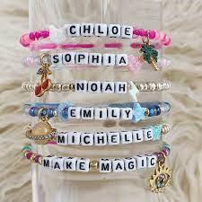 Bracelets of different colors using alphabet beads to spell out names in the middle..