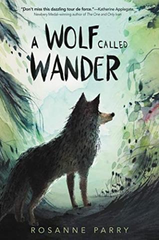 The book for "A Wolf Called Wander" by Rosanne Parry, featuring the back of a wolf looking forward in a forest. 