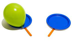 Two paper plates with a popsicle stick attached to each and a balloon