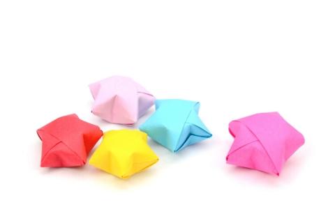 A photograph featuring colorful paper origami in the shape of stars.