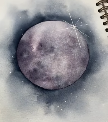 A picture of a moon watercolor in a sketchbook