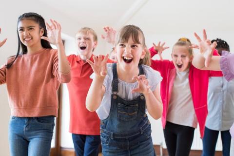 A group of kids playing a creative drama game