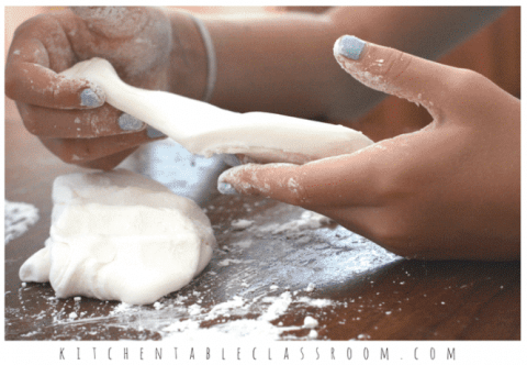 Hands kneading white clay. Photo credit: Kitchentableclassroom.com