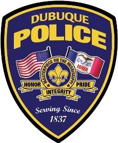 Dubuque Police badge containing the United States and Iowa flags featuring the words "Honor, Integrity, and Pride" on the bottom. The words "Masterpiece of the Mississippi" and "Serving Since 1837" are also on the badge. 