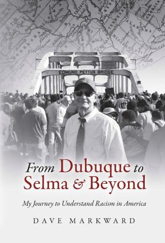 An image of the book cover for "From Dubuque to Selma & Beyond." The author, an older white male, is wearing sunglasses and a cap and standing in front of a busy crowd of people. Behind them is the bridge to Selma, Alabama, the Edmund Pettus Bridge and behind that is part of a map of the United States cropped to show the midwest and Alabama area. The image is in grayscale.