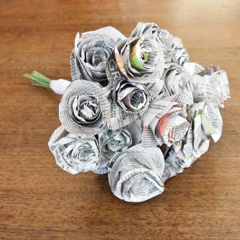 A bouquet of flowers made out of newspaper.