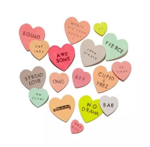 Many small hearts with the different phrases on them.