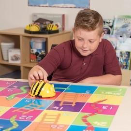 A child playing with a bee shaped robot.