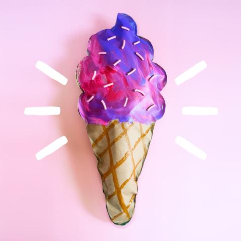 Photo of a puffy paper ice cream sculpture. The top is painted with pink and purple swirls; the bottom has a waffle cone pattern. Image is from BarleyandBirch.com