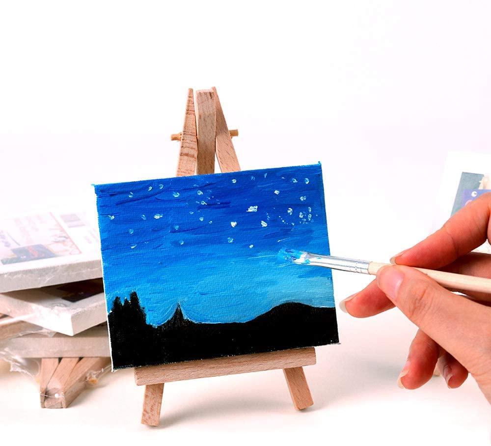 Photo of somebody painting a night sky on a tiny easel.