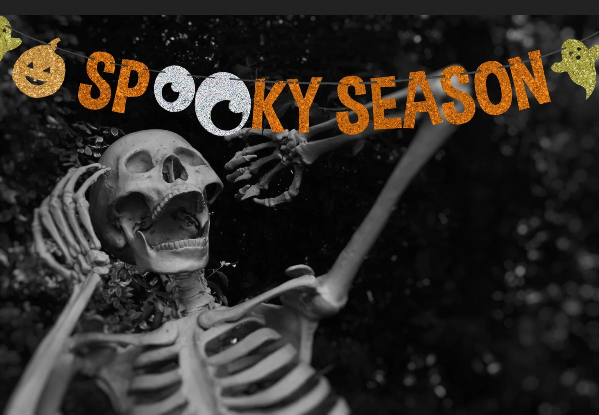 A skeleton celebrating under a banner saying "SPOOKY SEASON"