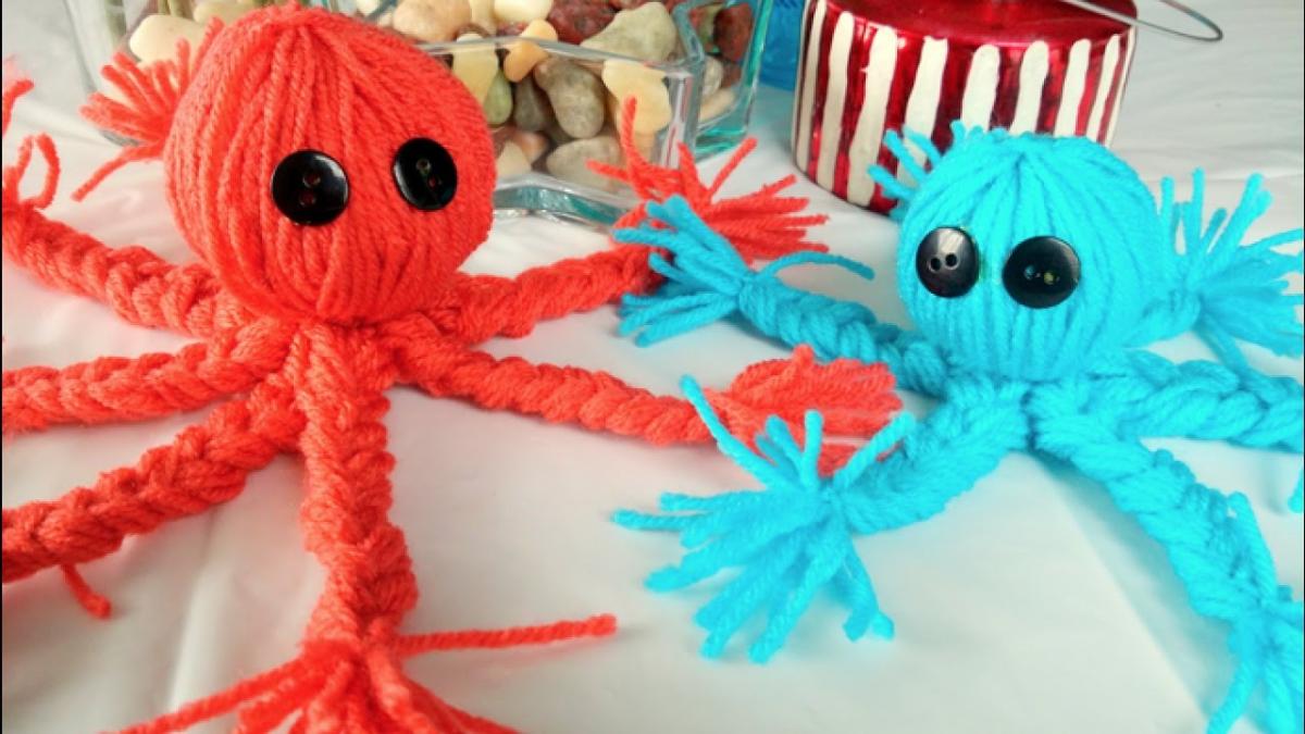 Image of one red and one blue octopus made from yarn.