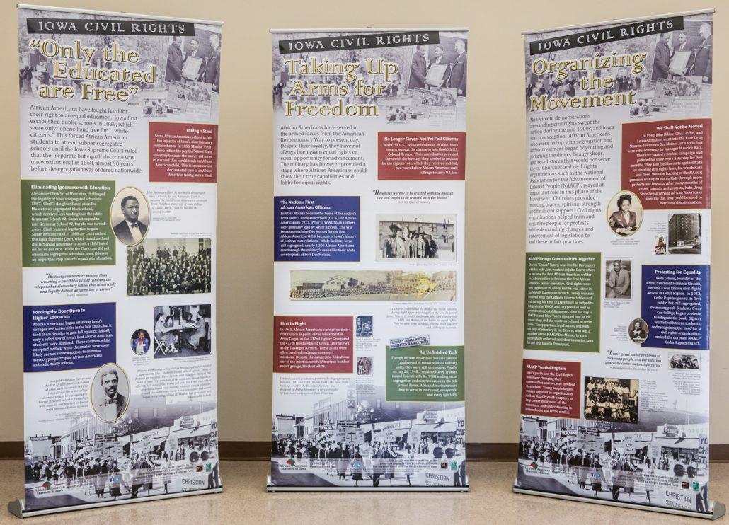 Photograph of travelling museum exhibit - three, free-standing banners with information and graphics related to the African American battle for civil rights.