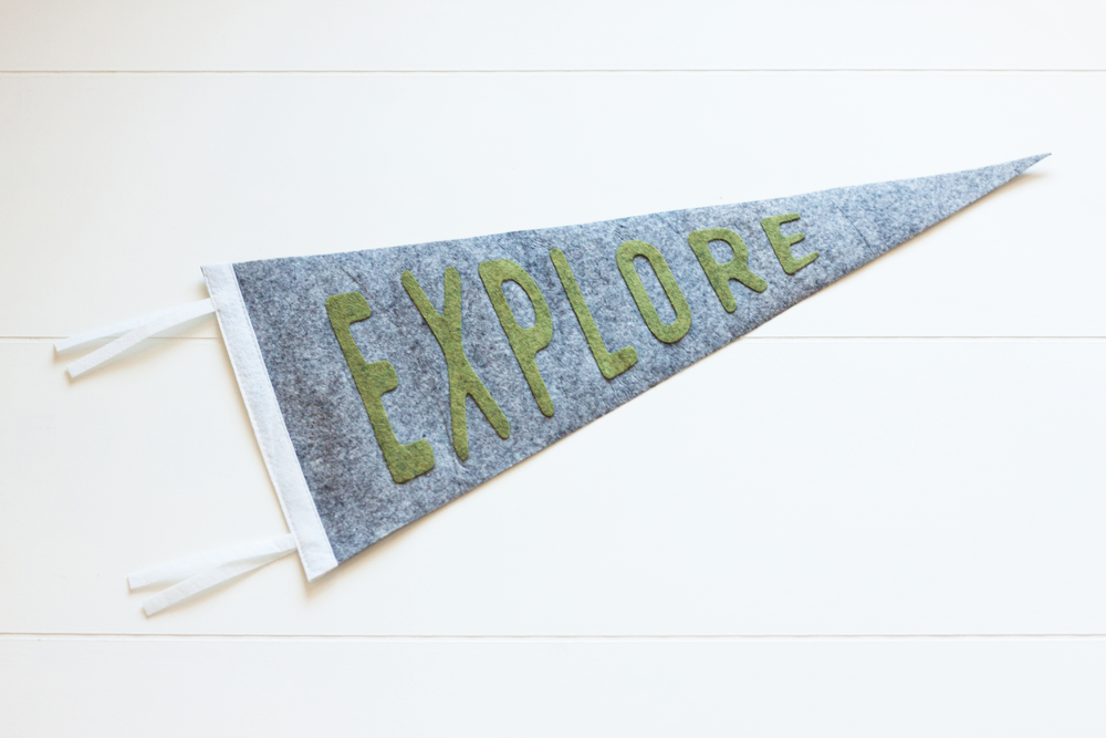 A picture of gray pennant that says "Explore" in green text