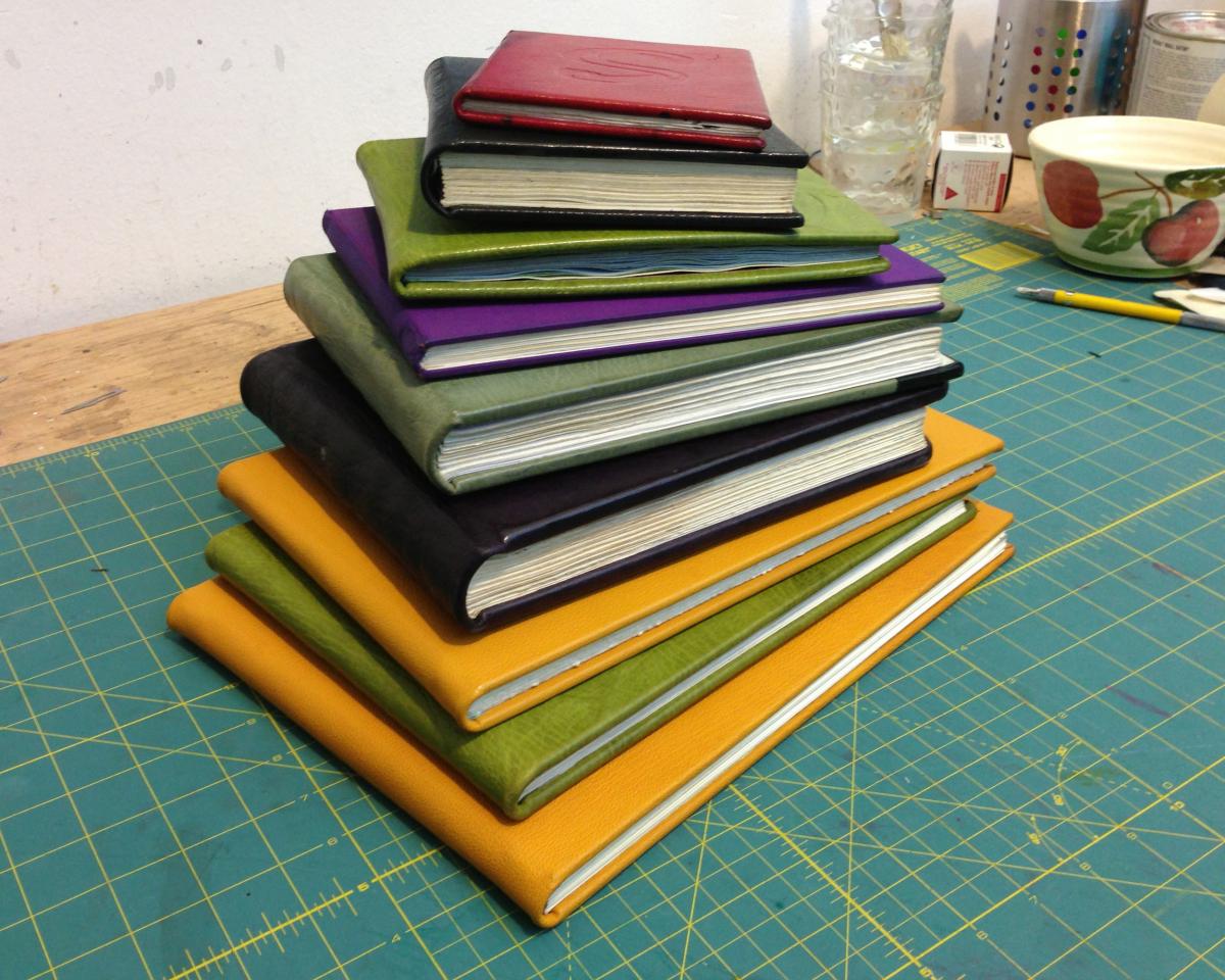 A stack of hand bound journals