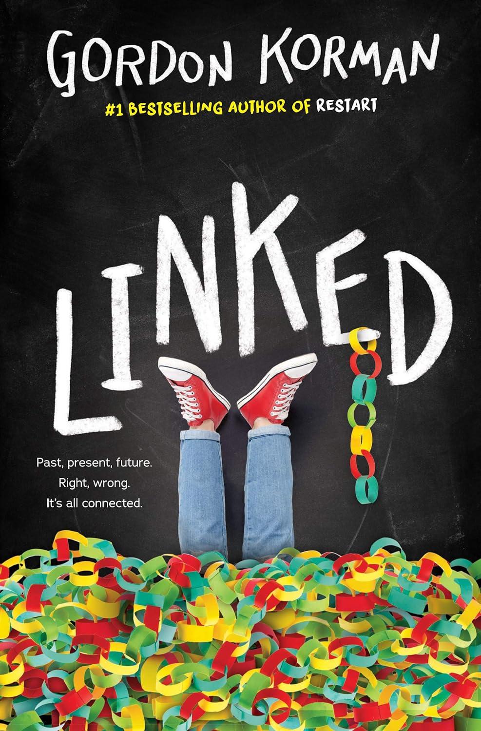 The cover of "Linked" by Gordon Korman, featuring a pair of legs wearing jeans and converse shows up in the air submerged in paper chains.