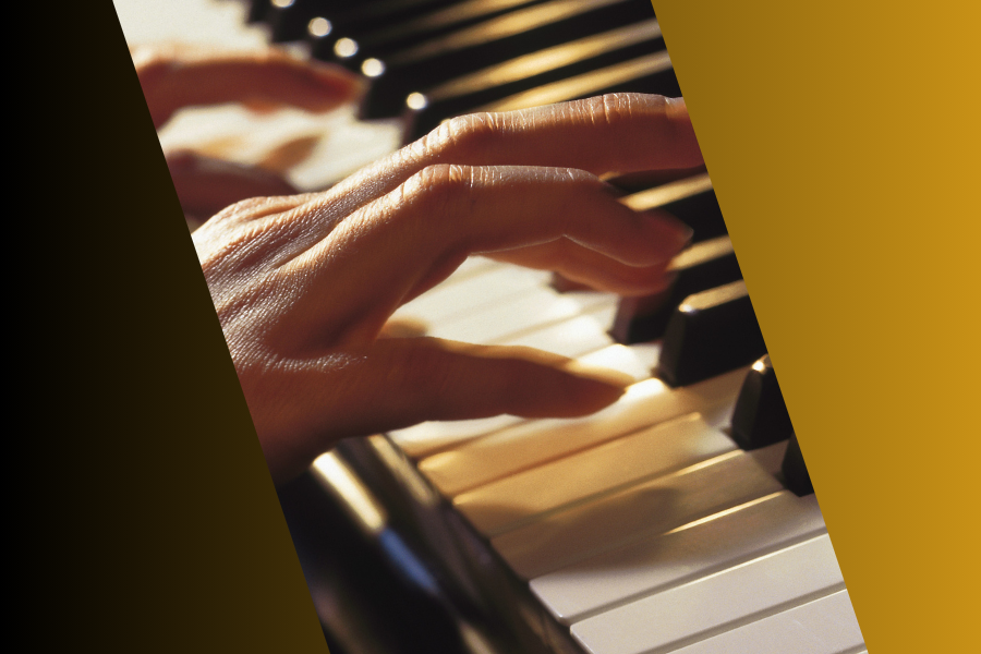 Close up image of hands about to strike piano keys.