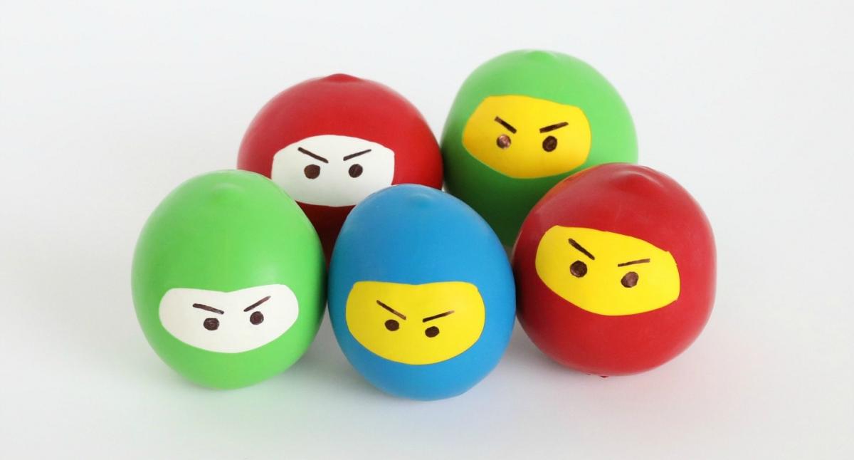 Colorful balls with yellow and white cutouts that look like ninjas.