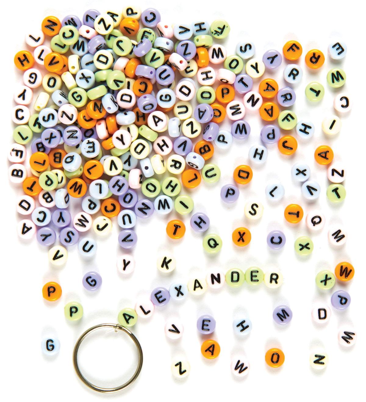 A pile of round multicolor beads with letters on them. 