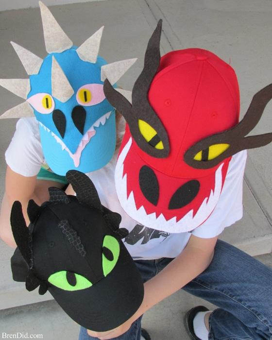 Three baseball hats decorated like dragons.