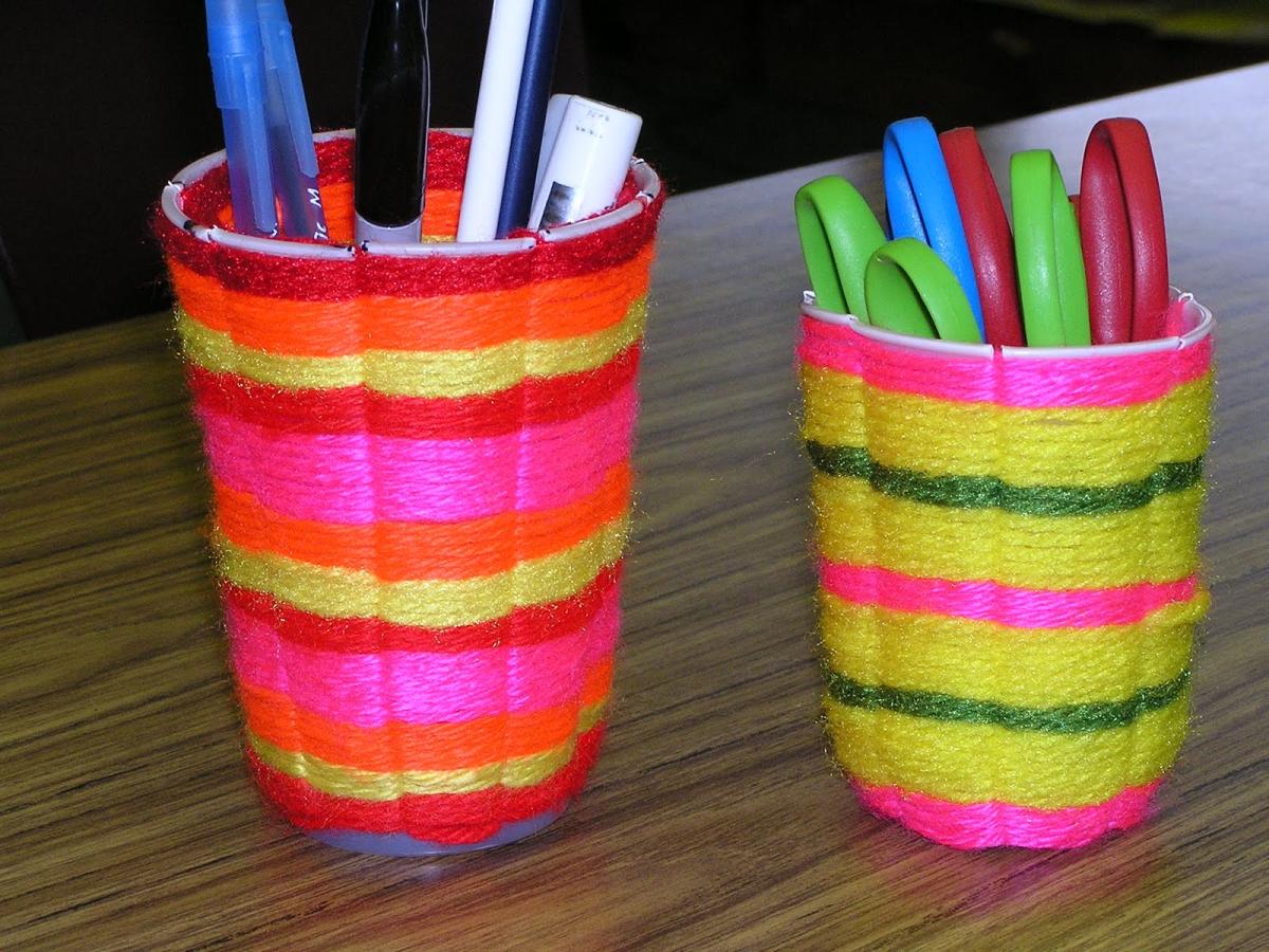 A photo of weaved cups holding sharpies.